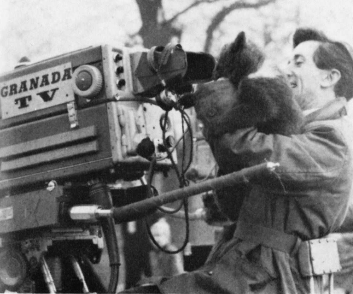 A man with a bear cub and a Granada camera