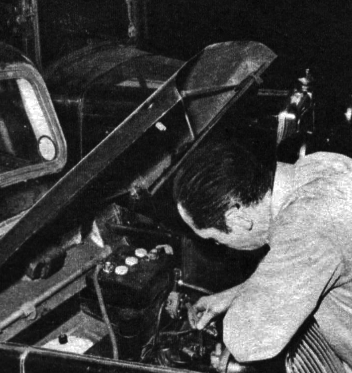 A man works on a car engine