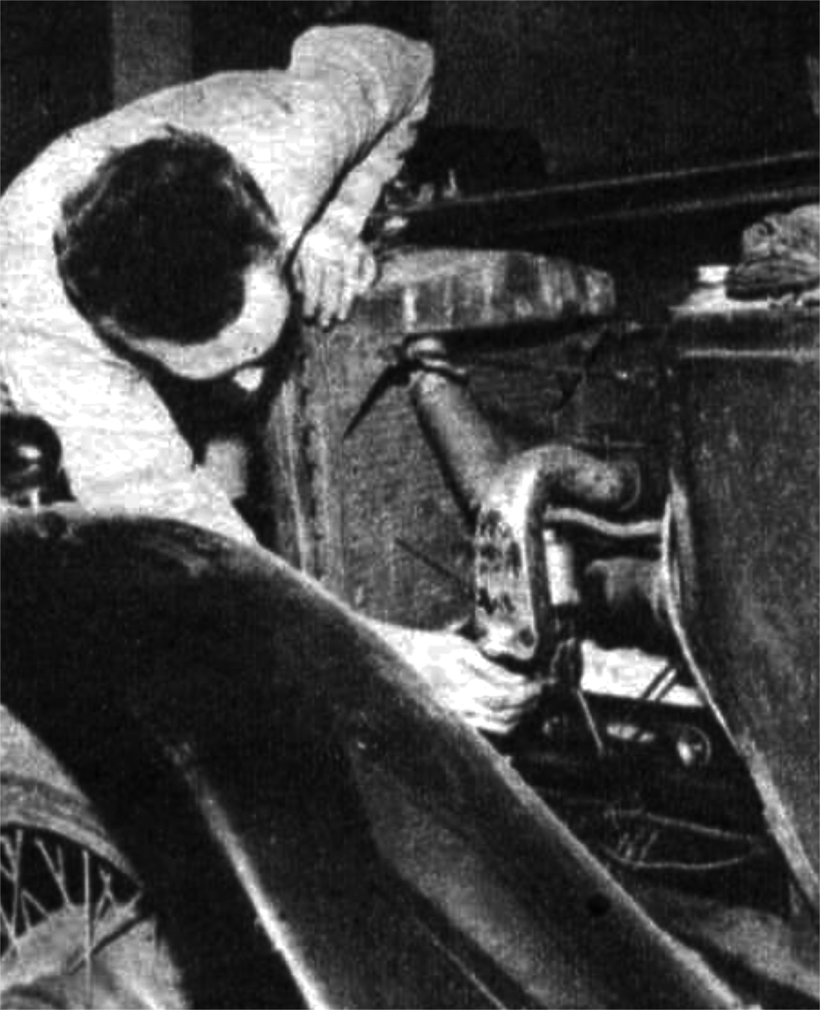 A man works on a car engine
